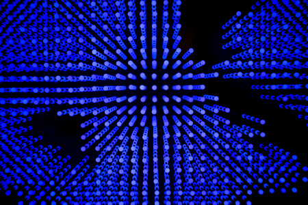 Abstract background composed of small blue circles on black.の写真素材