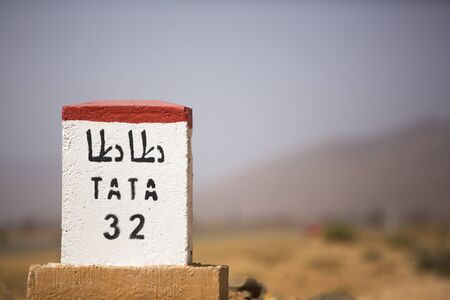 Tata 32 kilometres - road sign distance indicator on the road to Tata with blurred background, Moroccoの写真素材