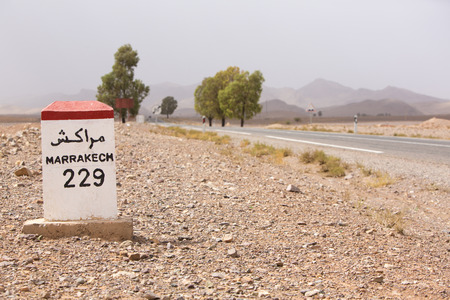 Marrakesh 229 kilometers - roadside distance indicator on the road to Marrakesh, Moroccoの写真素材