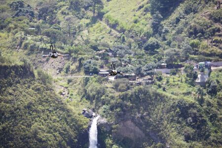 BANOS, ECUADOR, FEBRUARY 21: Unidentified people falling on a zip line adventure park in Ecuadorian rainforest, Banos de Agua Santa, the adventure capital of Ecuador 2015.のeditorial素材
