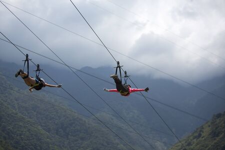 BANOS, ECUADOR, FEBRUARY 21: Unidentified people falling on a zip line adventure park in Ecuadorian rainforest, Banos de Agua Santa, the adventure capital of Ecuador 2015.のeditorial素材