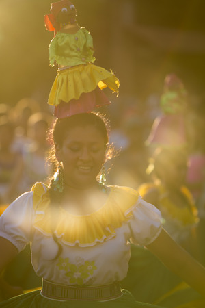 PUERTO AYORA, GALAPAGOS, FEBRUARY 13: Unidentified woman with traditional costume dancing in the street of Puerto Ayora during the official carnaval on Santa Cruz Island in the Galapagos Islands. Ecuador 2015.のeditorial素材