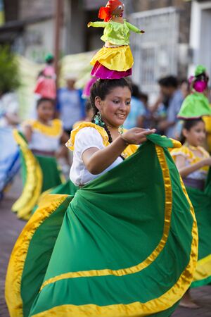PUERTO AYORA, GALAPAGOS, FEBRUARY 13: Unidentified woman with traditional costume dancing in the street of Puerto Ayora during the official carnaval on Santa Cruz Island in the Galapagos Islands. Ecuador 2015.のeditorial素材