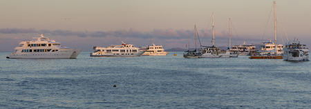GALAPAGOS ISLANDS, ECUADOR - FEBRUARY 12: Sunset and cruise ships in the port of Puerto Ayora....