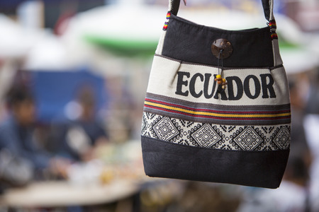 Handmade wool bag for sale at the outdoor craft market in Otavalo. Ecuador is written on the bag.の写真素材