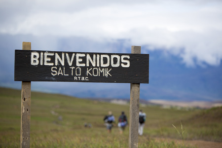 MOUNT RORAIMA, VENEZUELA, MARCH 31: Entrance wood sign to Canaima National Park. In the background three hikers walking, Gran Sabana. Venezuela 2015.のeditorial素材