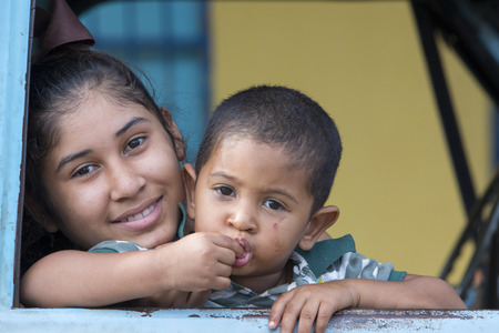 SANTA ELENA, VENEZUELA, APRIL 5: Unidentified portrait of young kid and his older sister sitting in a car and looking at the camera. Venezuala 2015.のeditorial素材
