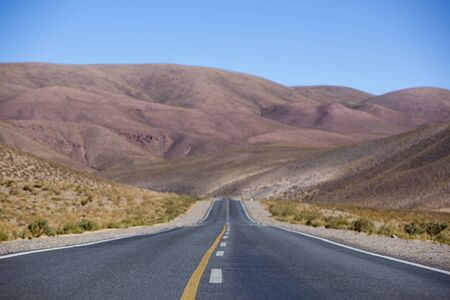 The famous Route 40 paved road parallel to the Andes against a blue sky and going towards the Salinas Grande, Jujuy Province. Argentina 2014の写真素材