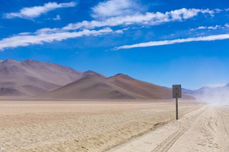 Off-road track in the Atacama desert, Bolivia with majestic colored mountains and blue sky in Eduardo Avaroa Andean Fauna National Reserve, Boliviaの写真素材