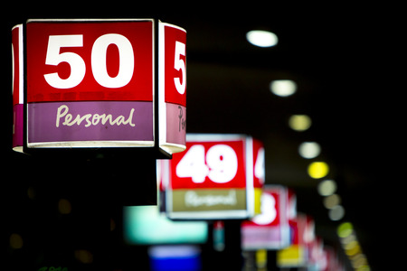 BUENOS AIRES, ARGENTINA, NOVEMBER 28: Colored illuminated gates with numbers at night at the Retiro Main Bus Terminal in Buenos Aires at night. Argentina 2014 (Selective focus)のeditorial素材