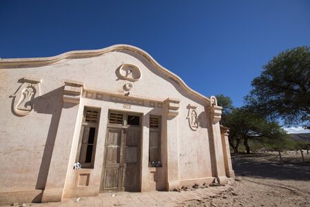 Old art deco style house near Cafayate with pairs of shoes standing on the window, located on the famous Ruta 40 (Route 40) within the Calchaqui Valleys in Salta Province. Argentinaのeditorial素材