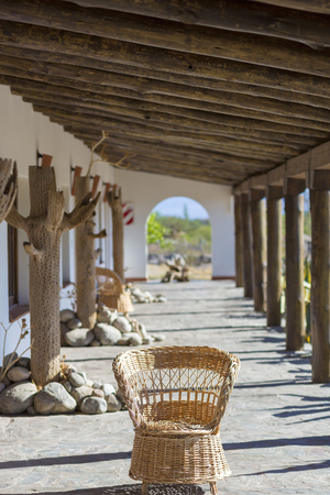 SALTA, ARGENTINA, DEC 26: Empty wicker chair located in the patio with sunrise light in local residential house in Cafayate, Salta Province. Argentina 2014 (Selective focus)のeditorial素材