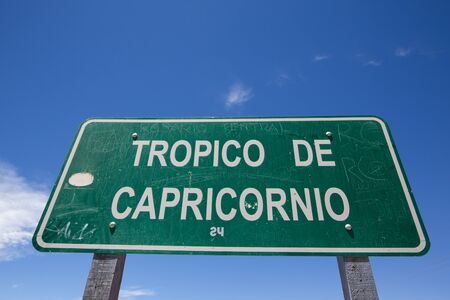 HUMAHUACA, ARGENTINA, DEC 22: Closeup of Tropic of Capricorn sign with personal signatures and names on the colorful valley of Quebrada de Humahuaca in Jujuy Province against a blue sky, Salta Province. Argentina 2014のeditorial素材