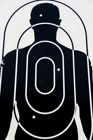 Black and white sign depicting the political status During The military dictatorship, shooting target on man. Parque de la Memoria in Buenos Aires, Argentina 2014 Memory Parkのeditorial素材