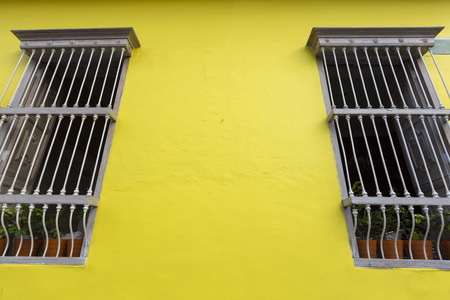 Bright yellow wall and window details, colonial architecture in Cali. Colombiaの写真素材