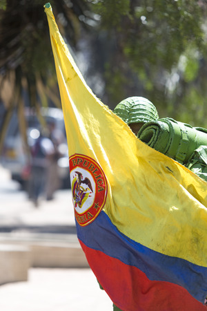 Colombian unknown artist playing the soldiers and holding the Colombia flag in the street of La Candelaria, Bogota - Colombia 2015のeditorial素材