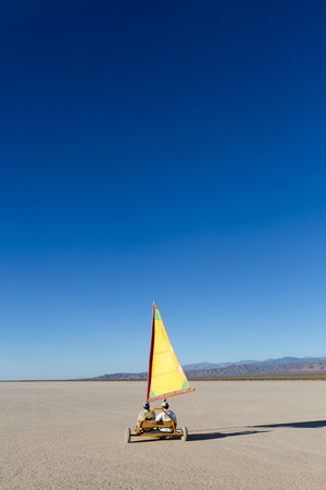Two men sails with buggy at the Pampa of El Leoncito with the Andean mountains and clear blue sky. San Juan Province, Argentina 2014のeditorial素材
