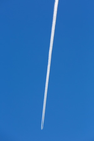 A jumbo airplane flying in high altitude in the sky of San juan Province, Argentinaの写真素材