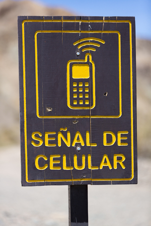 Direction road with sign cellular mobile phone signal road at El Alcazar pass on ruta 40 (Route 40), San Juan Province. Argentinaの写真素材