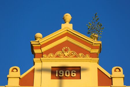 Details of the old colonial market facade build in 1906 in Manaus with sunset light ad clear blue...