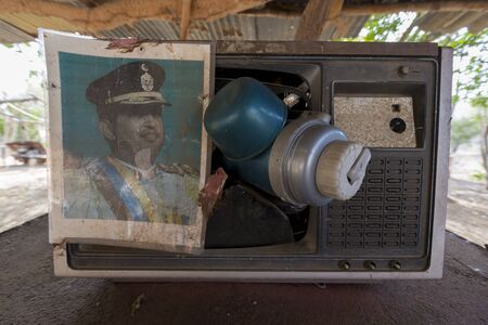 Vintage television with broken thermos and vintage photo of President vintage style standing on...