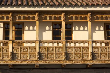 Colonial rustic wooden carved balconies on Plaza de Armas in the historic center of Cusco. Peruの写真素材