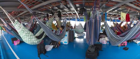 Panorama of people resting in hammocks passenger boat deck is going down the Amazon river entre LeticiaTabatinga and Manaus. Amazonas State. Brazil 2015のeditorial素材