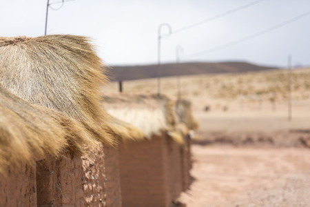 Details of adobe houses in Cerrillos village on Bolivian Altiplano near Eduardo Avaroa Andean Fauna National Reserve with cloudy blue sky, Boliviaの写真素材