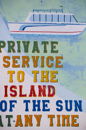 Vintage signs for local ferry services on wall painted on the Titicaca lake harbor in Copacabana, Bolivia 2015の写真素材