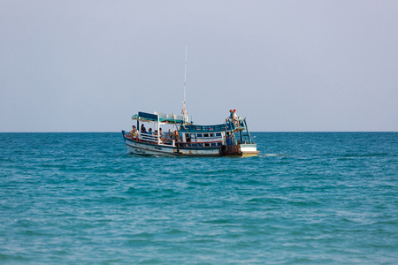 Sea view with traditional Khmer boat with tourists, beach of Koh Rong Island near Sihanoukville, Gulf of Thailand, Cambodia, South East Asia 2016のeditorial素材