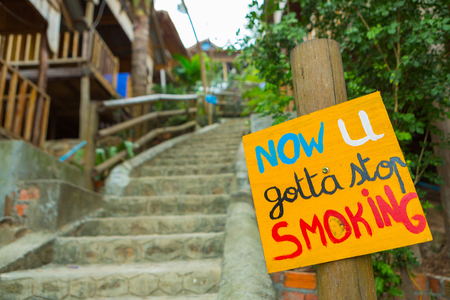 Quit smoking yellow sign with high stairs. Motivation sign to stop the nicotine.の写真素材