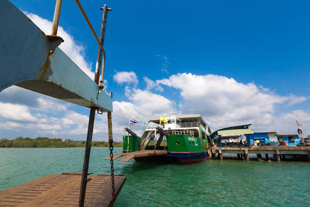 Front view of the ferry crossing the sea towards the island of Koh Chang with thai flags waving in the wind. Trat Province. Thailand.のeditorial素材