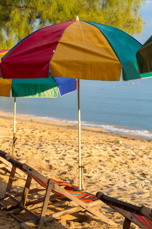 Colored beach chairs and colorful umbrellas standing on empty beach on Koh Chang Island. Trat Province. Thailandの写真素材