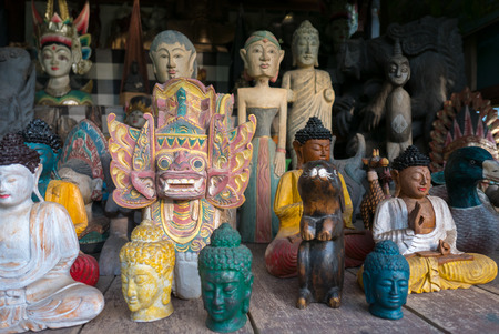 Group of different colored Balinese wooden statues displayed in art and craft tourist market in Ubud. Bali Island. Indonesiaの写真素材