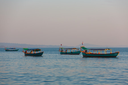 Beautiful sea view with traditional khmer boats, beach of Sihanoukville in the background, Gulf of Thailand, Cambodia, South East Asiaの写真素材