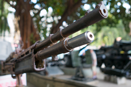 Details of a second world war gun placed on top of a Vietnamese vintage tank - Crawlers in Saigon. Vietnam. Selective focusの写真素材