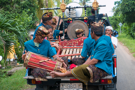 Group of senior Indonesian musicians playing music in the back of a lorry During the New Year Nyepi religious ceremony in the street of Negara - Bali, Indonesia in 2016のeditorial素材