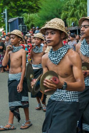 Group of young Indonesian men holding a giant sculpture Balinese New Year Nyepi During the religious ceremony in the street of Negara - Bali, Indonesia in 2016のeditorial素材