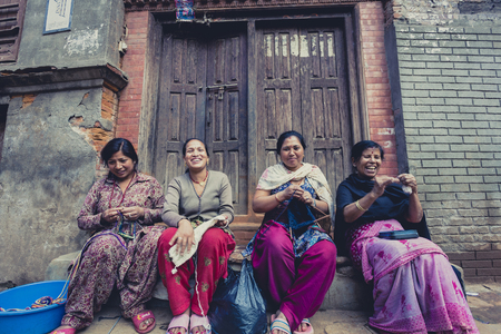 Group of women in Bhaktapur smiling and working in the street. Bhaktapur is one of 3 Royal cities in the Kathmandu Valley in Nepal and regarded a cultural gem, rich with a fascinating history. Nepal 2013.のeditorial素材