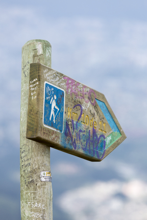 Trekking directional sign post with capital Quito in the background on the way to the volcano Pichincha, Ecuador 2015の写真素材
