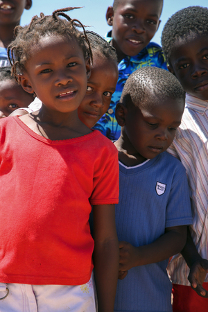 Group of Black African children posing in front of the camera in Swakopmund, a coastal city with sandy beaches facing the Atlantic Ocean. Namibia 2006のeditorial素材