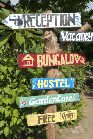 Various rustic hostel signs on wooden signpost in Bali. Indonesia 2016の写真素材