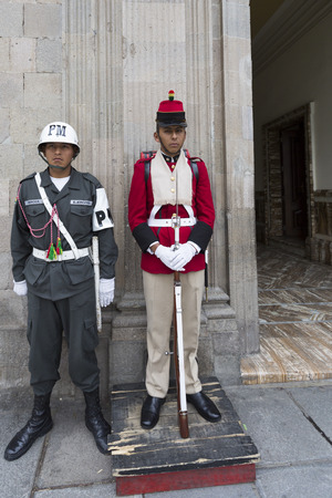 Military Police and traditional security guard standing at the entrance door of the Government Palace - The City Paz - Bolivia 2015のeditorial素材