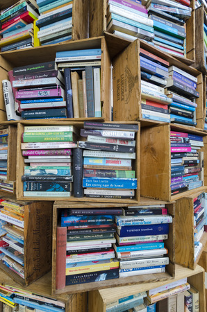Old used books on sale in small wooden boxes stacked in outdoors flea market in The Hague. Netherlands 2016のeditorial素材