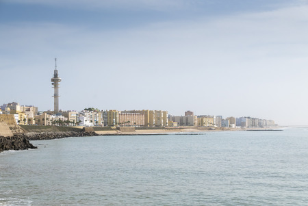 A view of the Cadiz waterfront in Spain with the Castillo de San Sebastian in the background.の写真素材
