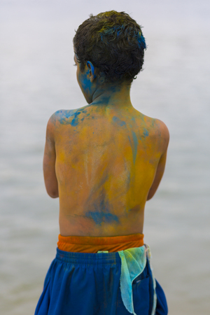 Rear view of Ecuadorian young boy playing with color painting During Carnival in Guayaquil in the popular district Ecuador. 2015の写真素材