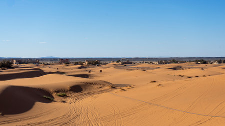Sunset light and footprints in the desert of Merzouga in Moroccoの写真素材