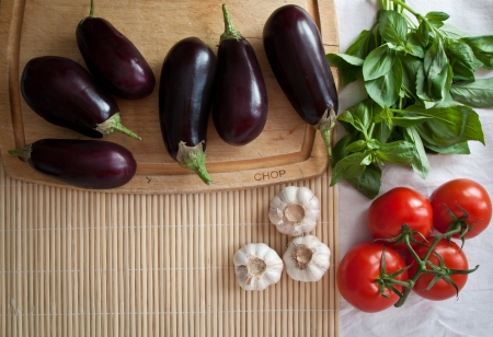 Mediterranean summer ingredients  aubergines, tomatoes, basil, garlic  Copy space の写真素材