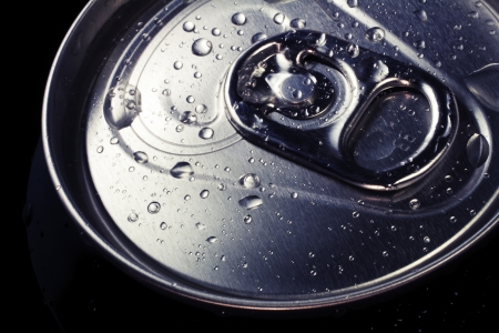 Drops of condensation on the lid of a cold drinks can  Cross-processed macro shot の写真素材