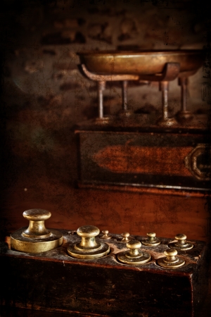Antique brass weights with scales in the background  Distressed texture for a retro feel の写真素材